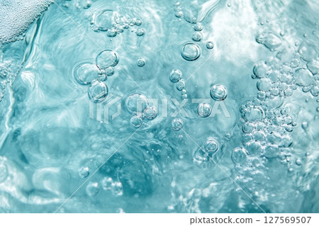 Close-up of abstract turquoise bubbles in liquid. Soft glow, smooth shapes, delicate texture. Macro shot with vibrant light. Fresh, pure, clean concept. Background, chemistry, skincare. Banner Close-up of abstract turquoise bubbles in liquid. Soft glow, smooth shapes, delicate texture. Macro shot with vibrant light. Fresh, pure, clean concept. Background, chemistry, skincare. Banner 127569507