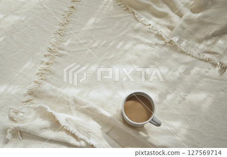 Real photo taken coffee mug ivory off white crinkle throw blanket shadow overlay morning lifestyle Real photo taken coffee mug ivory off white crinkle throw blanket shadow overlay morning lifestyle 127569714