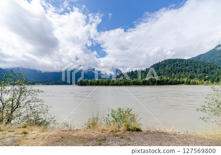 Fraser River with cloud covered green mountains in the background in Hope, BC, Canada 127569800