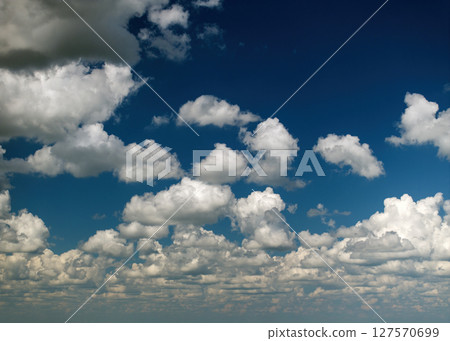 Bright landscape of blue sky with flying white clouds. Colorful summer skyscape Bright landscape of blue sky with flying white clouds. Colorful summer skyscape 127570699