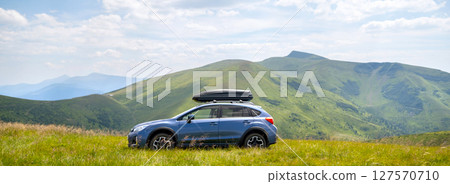 Blue off road car on mountain trail. Traveling by auto, adventure in wildlife, expedition or extreme travel on SUV automobile Blue off road car on mountain trail. Traveling by auto, adventure in wildlife, expedition or extreme travel on SUV automobile 127570710