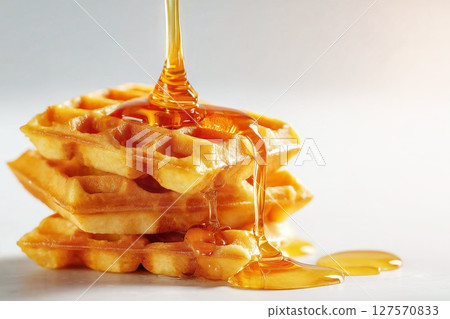 Freshly baked waffles and maple syrup Freshly baked waffles and maple syrup 127570833