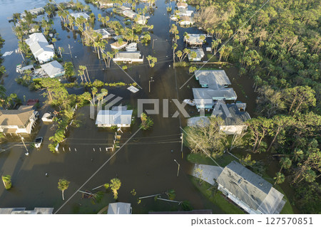 Aftermath of natural disaster. Surrounded by hurricane rainfall flood waters homes in Florida residential area Aftermath of natural disaster. Surrounded by hurricane rainfall flood waters homes in Florida residential area 127570851