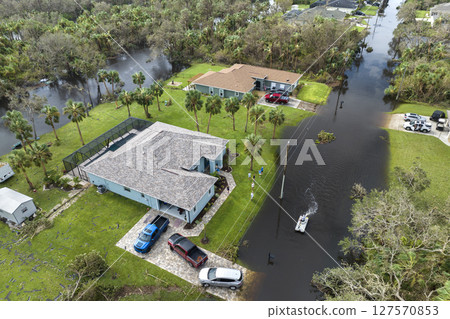 Aftermath of natural disaster. Surrounded by hurricane Ian rainfall flood waters homes in Florida residential area Aftermath of natural disaster. Surrounded by hurricane Ian rainfall flood waters homes in Florida residential area 127570853