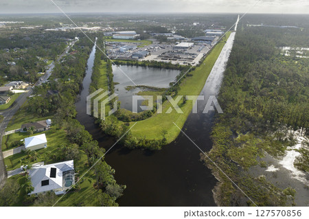 Aftermath of natural disaster. Flooded houses by hurricane rainfall in Florida residential area Aftermath of natural disaster. Flooded houses by hurricane rainfall in Florida residential area 127570856