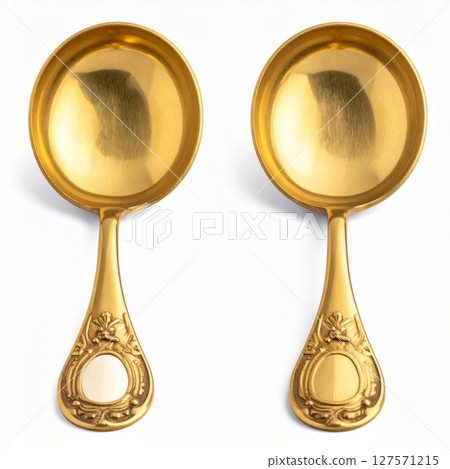 Pair of Antique Gold Spoons on White Background 127571215