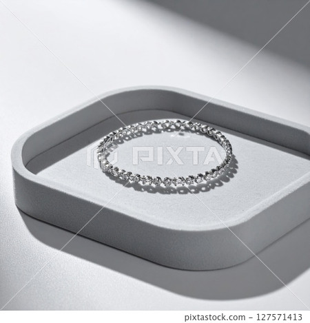 Silver Bracelet on Grey Tray, Minimalist Jewelry Product Photography 127571413