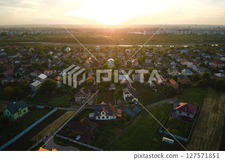 Aerial view of residential houses in suburban rural area at sunset Aerial view of residential houses in suburban rural area at sunset 127571851