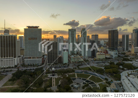 Aerial view of downtown district of of Miami Brickell in Florida, USA at sunset. High skyscraper buildings and street with cars and Metrorail traffic in modern american midtown Aerial view of downtown district of of Miami Brickell in Florida, USA at sunset. High skyscraper buildings and street with cars and Metrorail traffic in modern american midtown 127572120