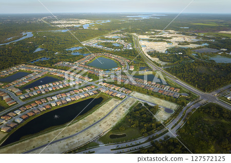 Aerial view of construction site with new tightly packed homes in Florida closed living clubs. Family houses as example of real estate development in american suburbs 127572125