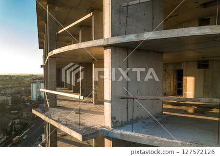 Aerial view of concrete frame of tall apartment building under construction in a city. Aerial view of concrete frame of tall apartment building under construction in a city. 127572126