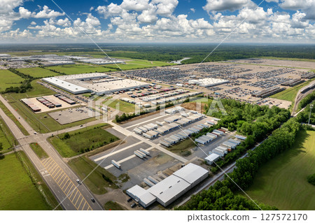 Aerial view of car factory parking lot with many brand new cars for sale. Development of American automotive industry concept Aerial view of car factory parking lot with many brand new cars for sale. Development of American automotive industry concept 127572170