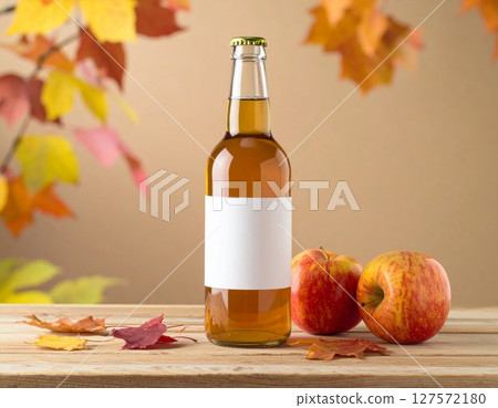 Apple Cider Bottle with Blank Label and Apples on Wooden Table 127572180