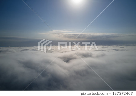 Aerial view from high altitude of earth covered with puffy rainy clouds forming before rainstorm Aerial view from high altitude of earth covered with puffy rainy clouds forming before rainstorm 127572467