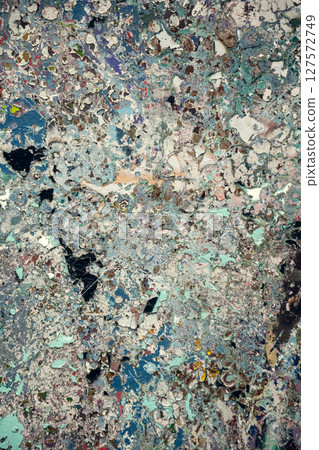 Detailed abstract texture of an aged and weathered surface featuring peeling paint in earthy and 127572749