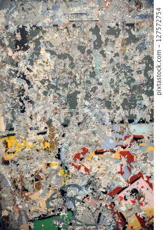 Abstract textured wall with layers of peeling paint and graffiti in mixed colors. 127572754