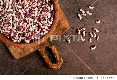 variegated beans, red with white spots, raw in a wooden bowl, top view, no people, 127573767