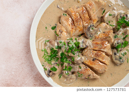 chicken in cream sauce with mushrooms, on a plate, no people 127573781
