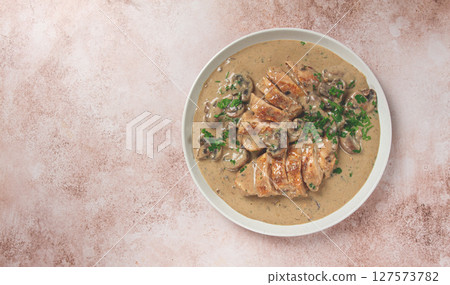 chicken in cream sauce with mushrooms, on a plate, no people 127573782
