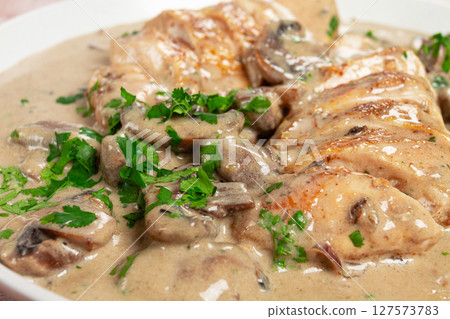 chicken in cream sauce with mushrooms, on a plate, no people chicken in cream sauce with mushrooms, on a plate, no people 127573783