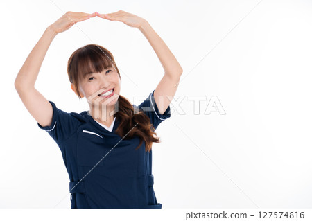 A middle-aged female nursing staff member making an OK pose A middle-aged female nursing staff member making an OK pose 127574816