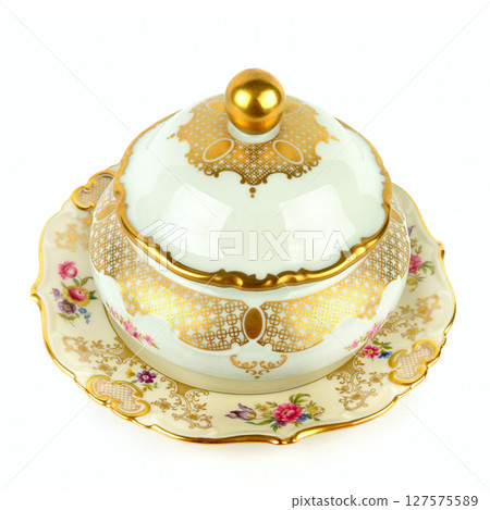 Porcelain vintage sugar bowl and a vintage porcelain plate isolated on white. Porcelain vintage sugar bowl and a vintage porcelain plate isolated on white. 127575589