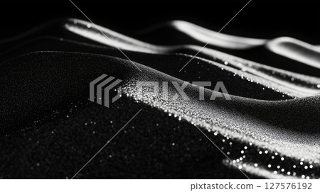 Monochrome close-up of wavy black sand 127576192