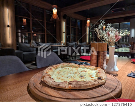 pizza on the table in a restaurant 127576410