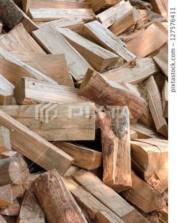 a pile of chopped firewood a pile of chopped firewood 127576411