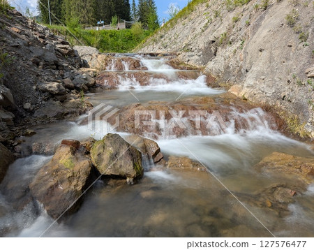 mountain river with a waterfall 127576477