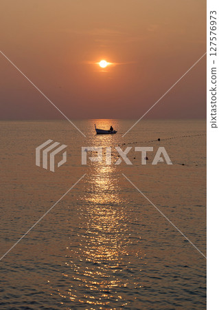 the atmosphere of the fishermen in the evening after returning home from fishing in the sea using a wooden boat the atmosphere of the fishermen in the evening after returning home from fishing in the sea using a wooden boat 127576973