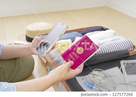 A woman checking a checklist on her smartphone A woman checking a checklist on her smartphone 127577266