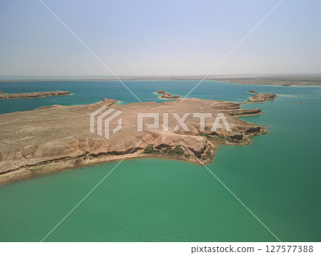Peninsula and turquoise bays of Kuimazar Reservoir under clear sky, Uzbekistan Peninsula and turquoise bays of Kuimazar Reservoir under clear sky, Uzbekistan 127577388