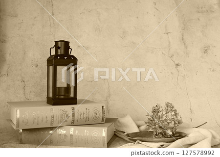 Scenery with antique lantern and books 127578992