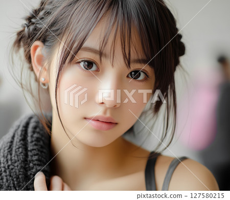 A cute young woman with impressive big eyes 127580215