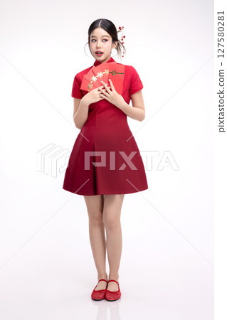 Portrait of joyful beauty Asian woman in red Cheongsam Chinese traditional dress celebrating with lucky red envelopes on Chinese New Year festival isolated on white background. 127580281