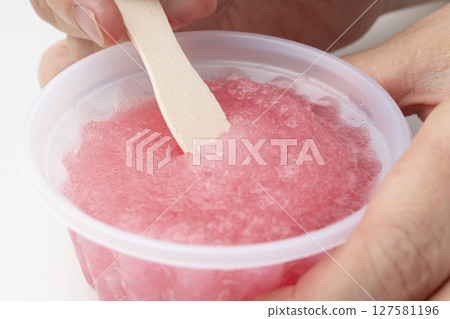 Strawberry shaved ice, strawberry ice, lifted with a wooden spoon Strawberry shaved ice, strawberry ice, lifted with a wooden spoon 127581196