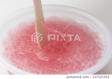 Strawberry shaved ice, strawberry ice, lifted with a wooden spoon Strawberry shaved ice, strawberry ice, lifted with a wooden spoon 127581203