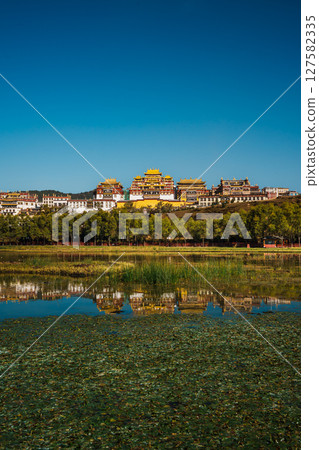 Songzanlin Monastery Reflecting in a Tranquil Lake in Shangri la 127582335