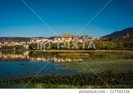 Songzanlin Monastery Reflecting in a Tranquil Lake in Shangri la 127582336