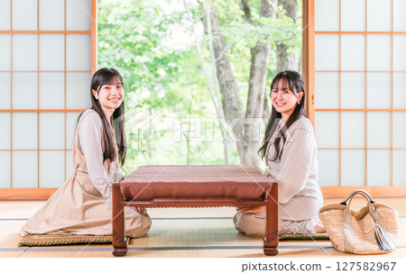 Young Asian woman on a girls trip to a ryokan/onsen ryokan (travel/Japanese-style room) 127582967