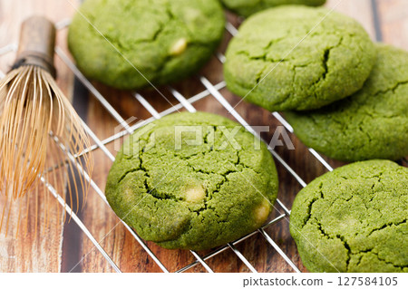 Chewy matcha chocolate chip cookies on cooling rack. Chewy matcha chocolate chip cookies on cooling rack. 127584105