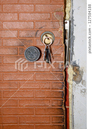 old front door to house with lock and keys old front door to house with lock and keys 127584188
