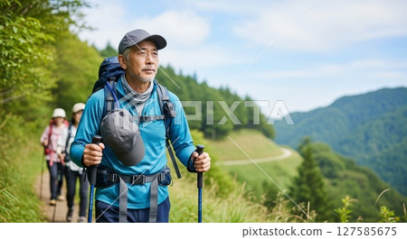 Senior man and friends enjoying hiking Senior man and friends enjoying hiking 127585675