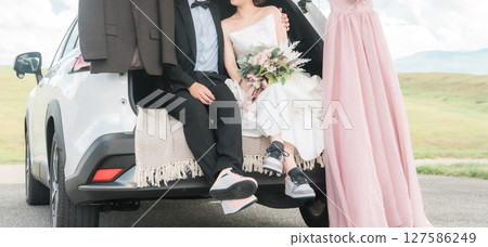 Bride and groom/couple taking wedding photos in a car wedding/bridal car Bride and groom/couple taking wedding photos in a car wedding/bridal car 127586249