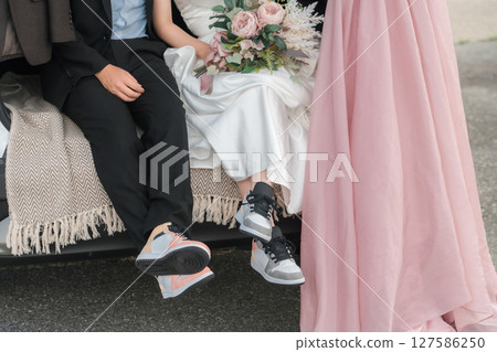 Bride and groom/couple taking wedding photos in a car wedding/bridal car Bride and groom/couple taking wedding photos in a car wedding/bridal car 127586250