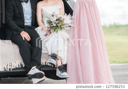 Bride and groom/couple taking wedding photos in a car wedding/bridal car 127586251