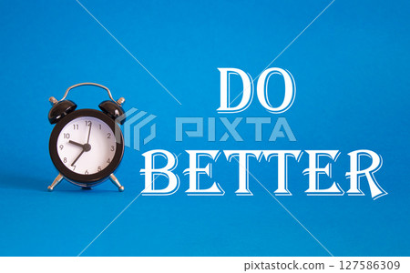 Do better symbol. Beautiful blue background with alarm clock. Business and Do better concept. Copy space. Do better symbol. Beautiful blue background with alarm clock. Business and Do better concept. Copy space. 127586309