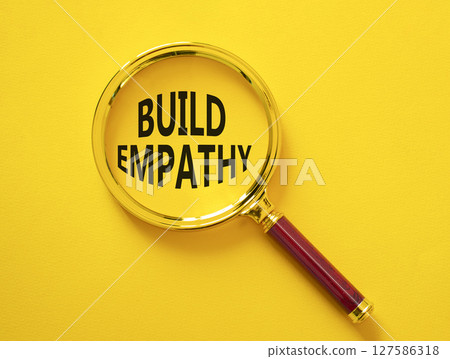 Build empathy symbol. Magnifying glass with words Build empathy. Beautiful yellow background. Business and Build empathy concept. Copy space. Build empathy symbol. Magnifying glass with words Build empathy. Beautiful yellow background. Business and Build empathy concept. Copy space. 127586318