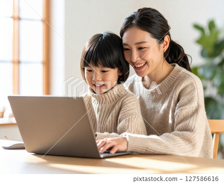 Parent and child learning to use a computer in the living room 127586616
